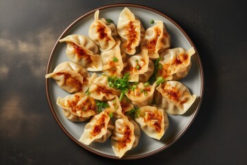 Top view of gyoza dumplings on a plate against a gray concrete background