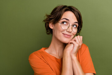 Portrait of girlish sweet young pretty woman hands together looking empty space dreaming about...