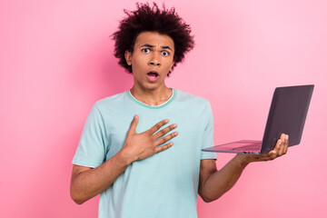 Photo of impressed shocked man dressed blue t-shirt reading news modern gadget isolated pink color background