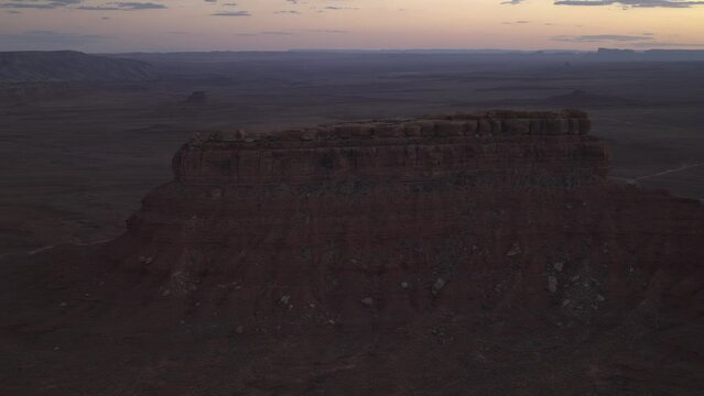 Aerial view of red rock formation at sunset