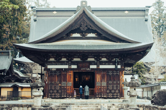 Two people praying at Japanese Temple 