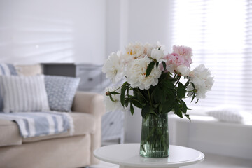Bouquet of beautiful peony flowers on table indoors