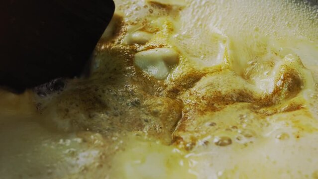 Vareniki dumplings are cooked in a saucepan in boiling water with cumin and turmeric. Close-up.
