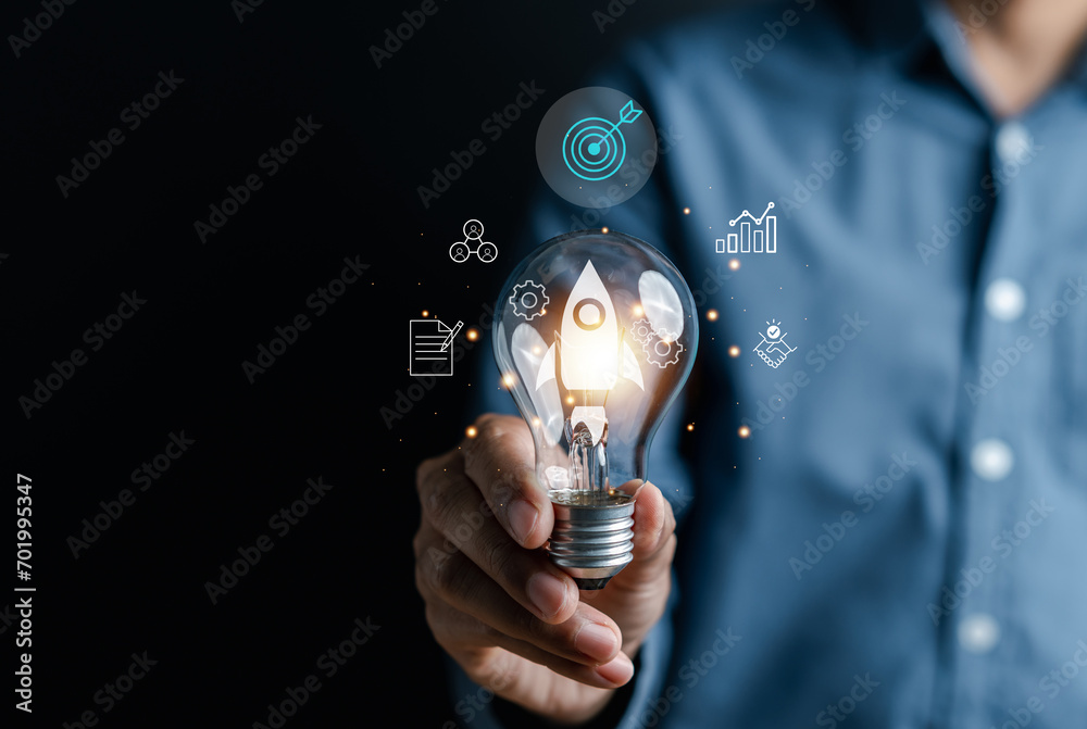 Fototapete rocket launch idea inside lightbulb with arrows up. strategically planning and initiating a corporat