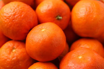 Many fresh ripe tangerines as background, closeup