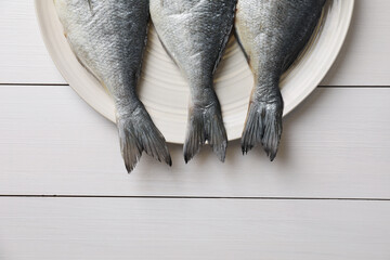 Fresh raw dorado fish on white wooden table, top view. Space for text
