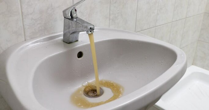 Contaminated dirty tap water flowing