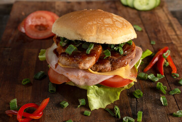 Homemade fresh meat burgers with potato bread with egg bacon tomato lettuce onion cheddar cheese ham dressings different varieties with fries fast food