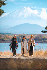 Happy tourist traveler woman or man enjoying on lake kawaguchiko with mount fuji in japan, spring and summer, Japan travel vacation site