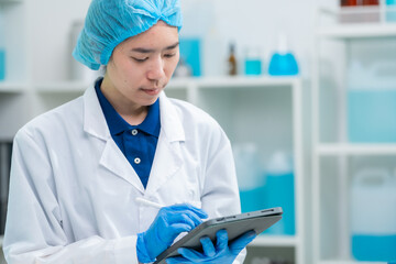 Scientist or medical technician working, having a medical discuss, senior female scientist supervisor in the laboratory reading a test samples and innovation, Asian woman worker