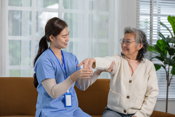 Asian female doctor advise elderly patient and diagnosis or check up to physiotherapist to exercise stretching muscle at home or premuim clinic.Physiotherapist Nursing