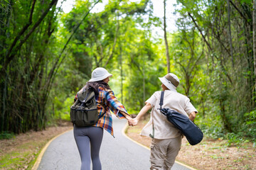 Happy LGBTQ person enjoy and fun outdoor lifestyle travel forest mountain on summer holiday vacation. Asian lesbian couple hiking and playing together in the jungle with looking beautiful nature.