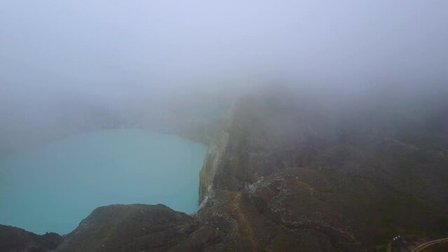 Early morning misty aerial view of the Kelimutu three colored lakes in East Nusa Tenggara, Indonesia.