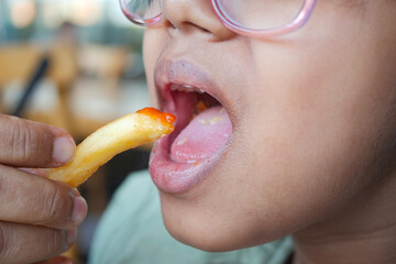  child eating french fries close up 