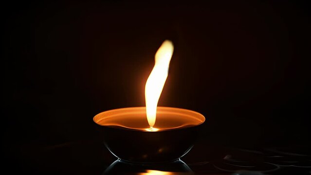 A candle burning in the darkness, its flickering flame casting shadows on the surrounding objects, reminding us that even in the darkest of times, love can light the way.
