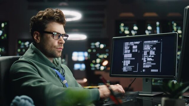 IT programer working keyboard desktop computer data center control room closeup