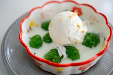 Inthanin dessert or Yoksod Pandan Ball in coconut milk with coconut milk ice cream, traditional Thai dessert
