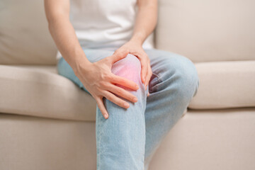 woman having knee ache and muscle pain due to Runners Knee or Patellofemoral Pain Syndrome,...