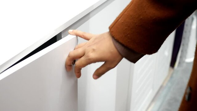  women hand open drawer wooden in cabinet