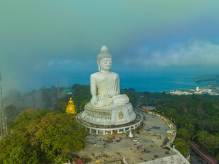 aerial photography scenery blue sky and blue ocean behind Phuket white big Buddha..Fog cover Phuket white big Buddha is the famous landmark in Phuket..Aerial panoramic view landscape Phuket big 