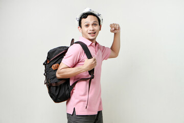 Asian man backpackershowing strength gesture with arms. digital nomad and travelling concept. on isolated background