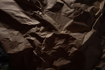 Brown old crumpled paper texture in low light background,wrinkled paper - 702025729