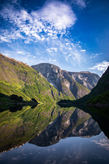 Naklejka na ściany i meble landscape with mirror lake, mountains and blue sky