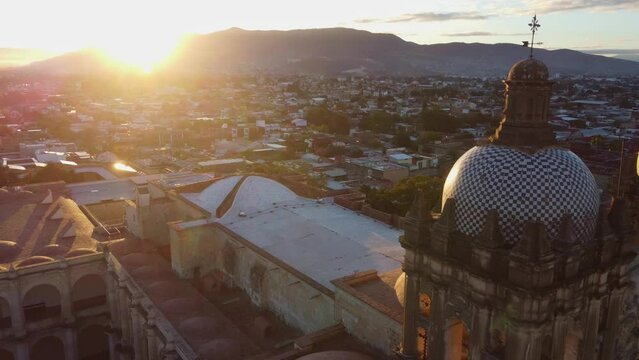 backwards drone shot of Santo Domingo temple in downtown Oaxaca city in Mexico