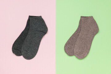 Two pairs of short socks on a two-tone background.
