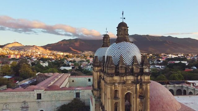 backwards drone shot of Santo Domingo temple in downtown Oaxaca city in Mexico
