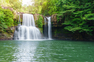 Klong Chao waterfall serenely cascades and green water below in Koh Kood island, Thailand.