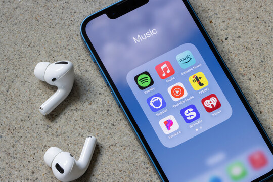 Portland, OR, USA - Jan 1, 2024: Assorted music streaming apps, including Spotify, Apple Music, Amazon Music, Napster, YouTube Music, TREBEL, Pandora, SiriusXM, and iHeart, are seen on an iPhone.