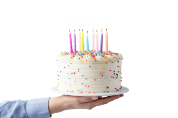 Hand holding a birthday cake with buttercream and colorful candles isolated on a transparent background. PNG file.
