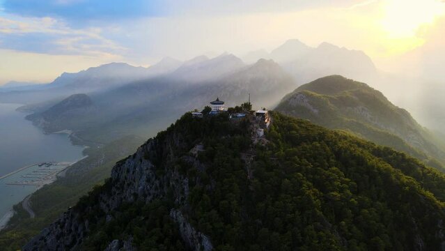 Aerial 4K drone video of a Tunektepe Teleferik
Cable station positioned on top of the hill with the mountains in the background. View point and attraction located in Antalya, Turkey.