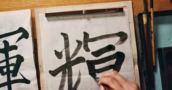 Top, Asian writing or script with brush and ink, calligraphy or ancient Japanese font with stationery and stroke. Writer, person with traditional or vintage tools for letter or alphabet with closeup