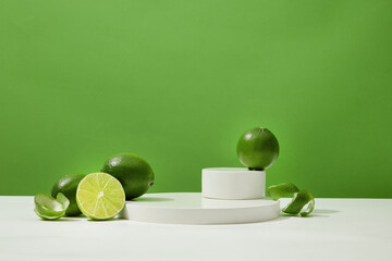 Fresh lemons are decorated around the display platform on a white surface with a green background....