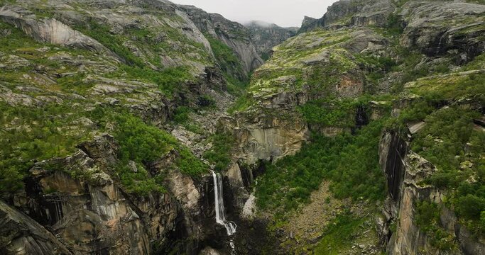 Scenic Rugged Mountains With Hellmojuvet Canyon Waterfall In Northern Norway. Aerial Drone Shot