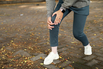 Joint pain, Arthritis and tendon problems. an asian muslim woman touching knee at pain point in the...