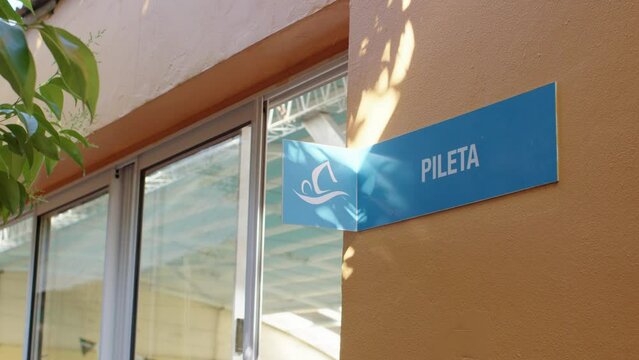 Clear signage directing the way to the pool area, guiding individuals to its location with ease during the day