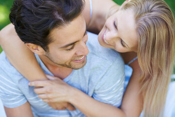 Couple, hug and relax in park with smile, love and commitment in healthy relationship. People on a...