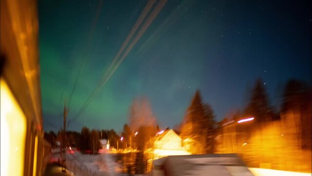 Hyperlapse of northern light over a dark sky in scandinavia seen from a moving train.