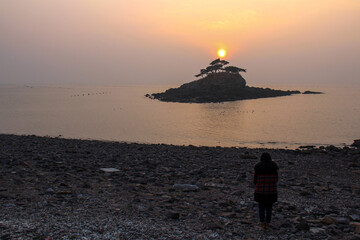 the ebb and flow of the tide to a small island in the sea