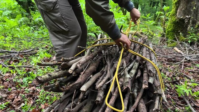 tie a rope knot in forest wilderness survival in Iran Hyrcanian jungle Azerbaijan UNESCO site ecotourism hiking activity lodge resort burn wood fire campfire dry wooden stick tree branch bread bake
