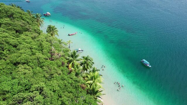 Drone forward shot of Estrella beach and some boats located in the Caribbean Sea in Bocas del Toro, Panama. South Atlantic Ocean.