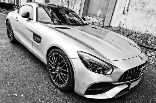 Kaliningrad, Russia - OCTOBER 31, 2023: Front on view of a Mercedes-Benz AMG GTS 510 sports car are parked in courtyard. Image contain noise or grainy. 