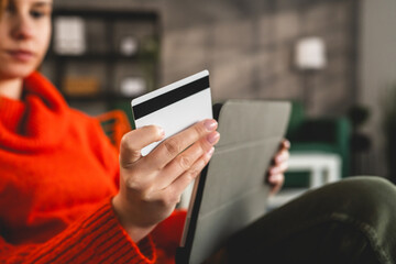 Close up on hand of unknown woman hold credit card shopping online