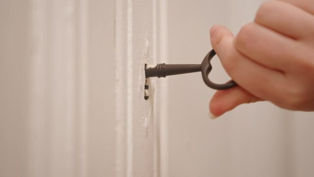 A Person Is Opening A Closet Using Antique Key. Closeup Shot