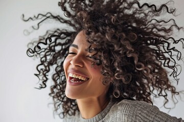 a woman with curly hair laughing