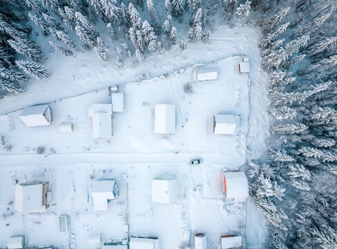 Aerial view of a small settlement in the forest during winter
