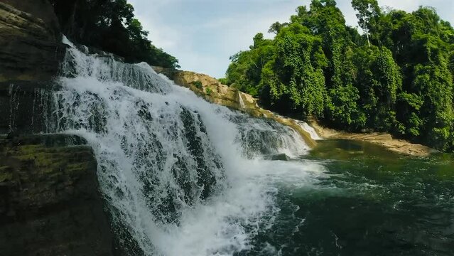 Water cascading over the rock level structures. Tinuy-an Falls. Bislig, Surigao del Sur. Philippines.